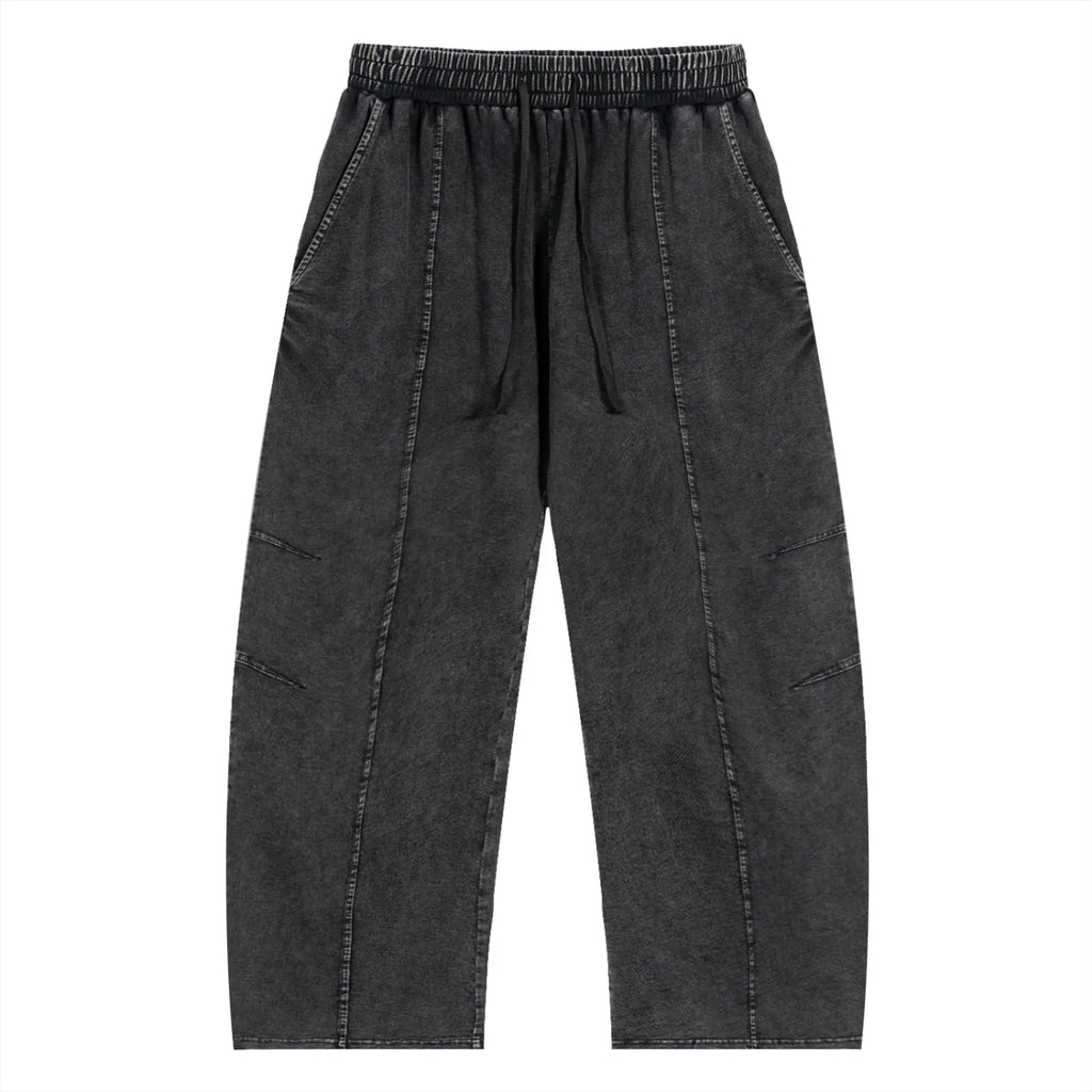 Black washed streetwear jogger pants with elastic waistband and stitched details, front view