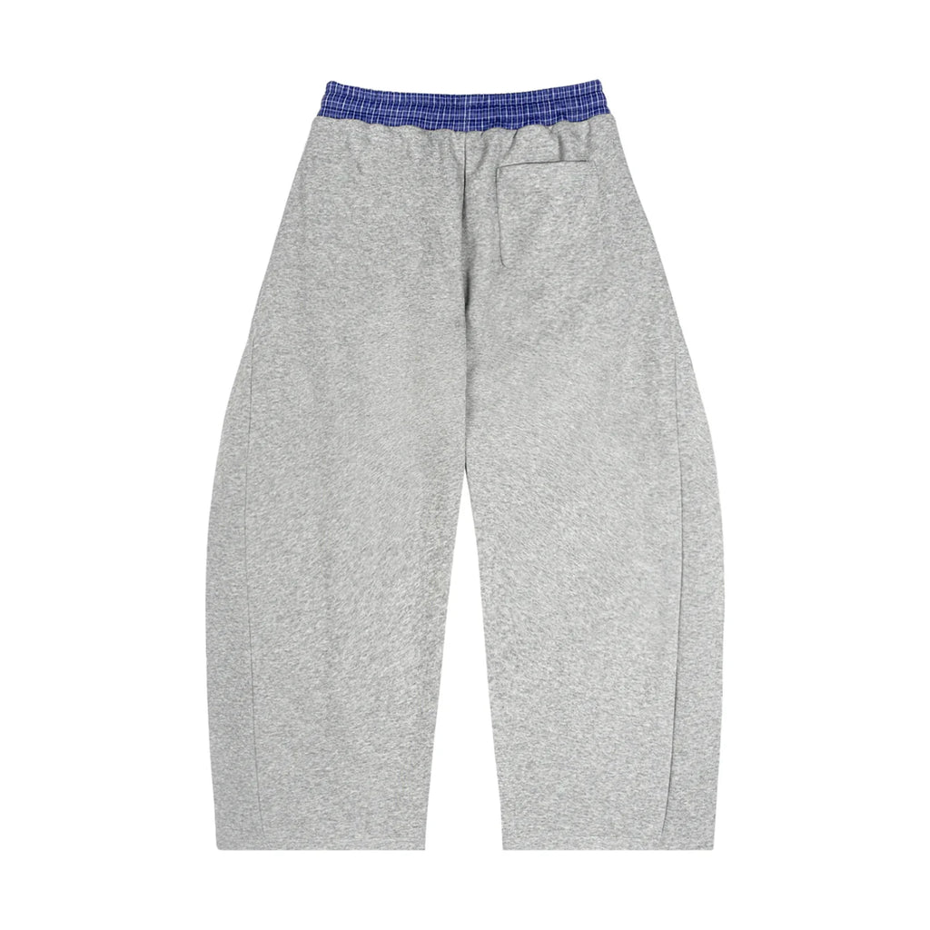Gray oversized sweatpants with blue elastic waistband and back pocket, streetwear style.
