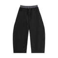 Wide-leg black sweatpants with elastic drawstring waist and side pockets, streetwear style