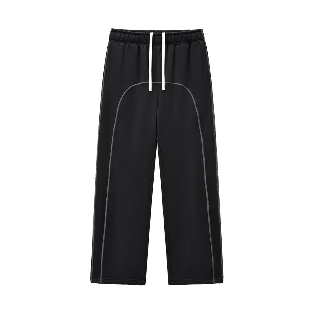 Black streetwear jogger pants with white drawstring and curved stitching, modern urban style