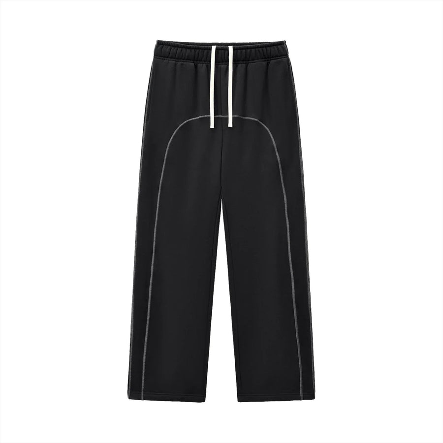 Black streetwear jogger pants with white drawstring and curved stitching, modern urban style