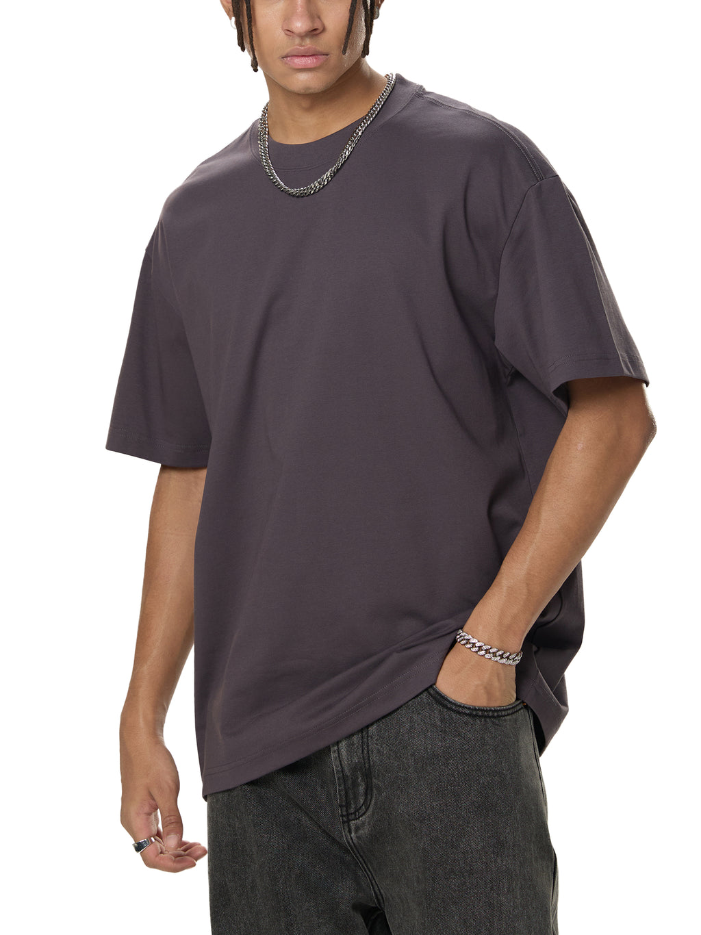 Man in oversized charcoal t-shirt and black jeans, modern streetwear style