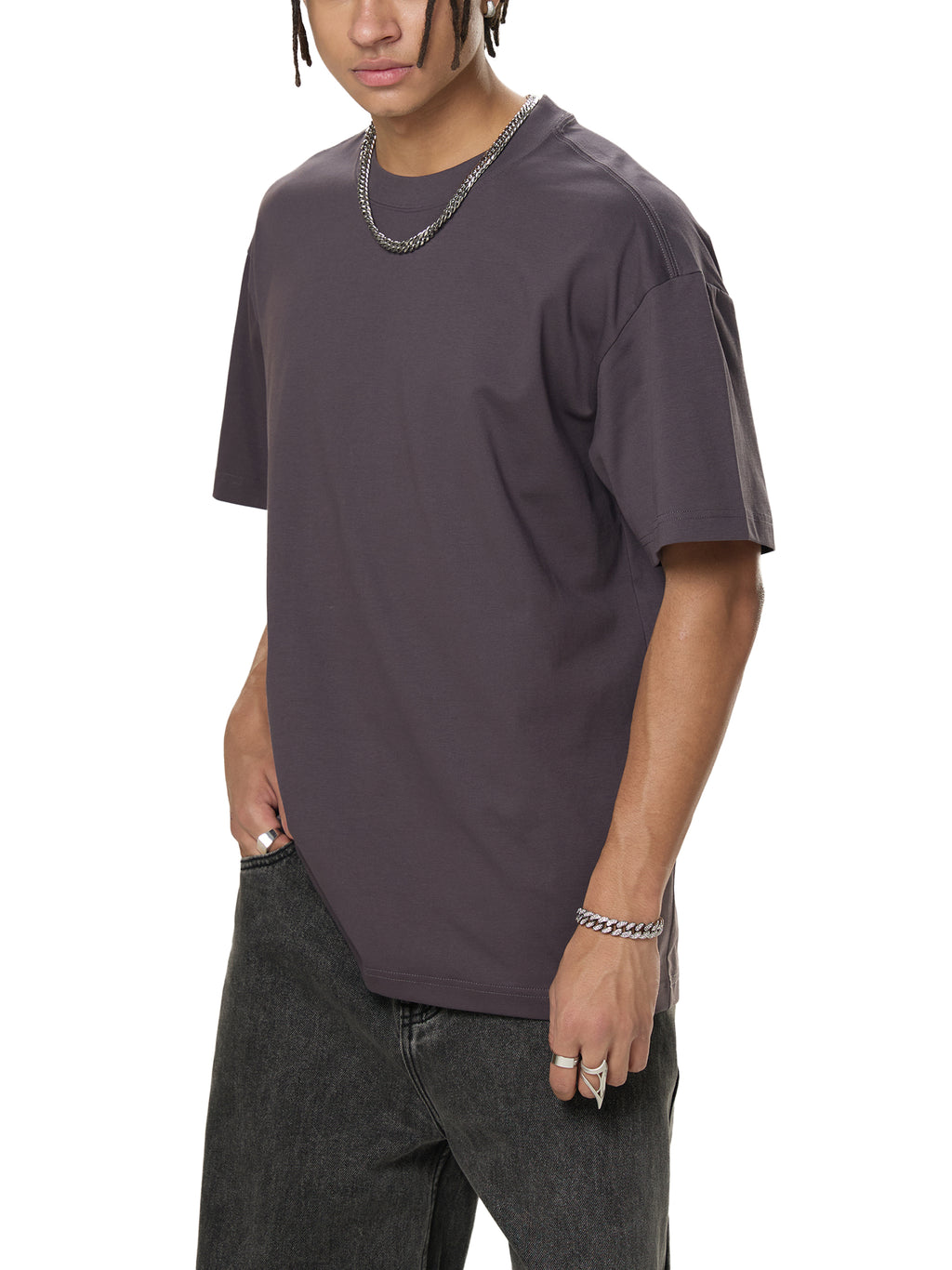 Man in oversized dark grey t-shirt and black jeans, modern streetwear style