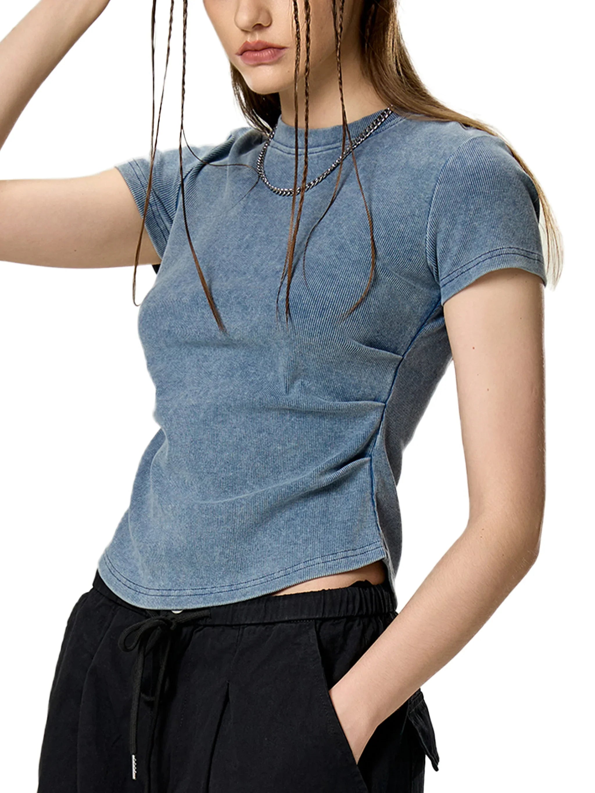 Woman wearing fitted blue washed t-shirt and black drawstring pants, modern streetwear style