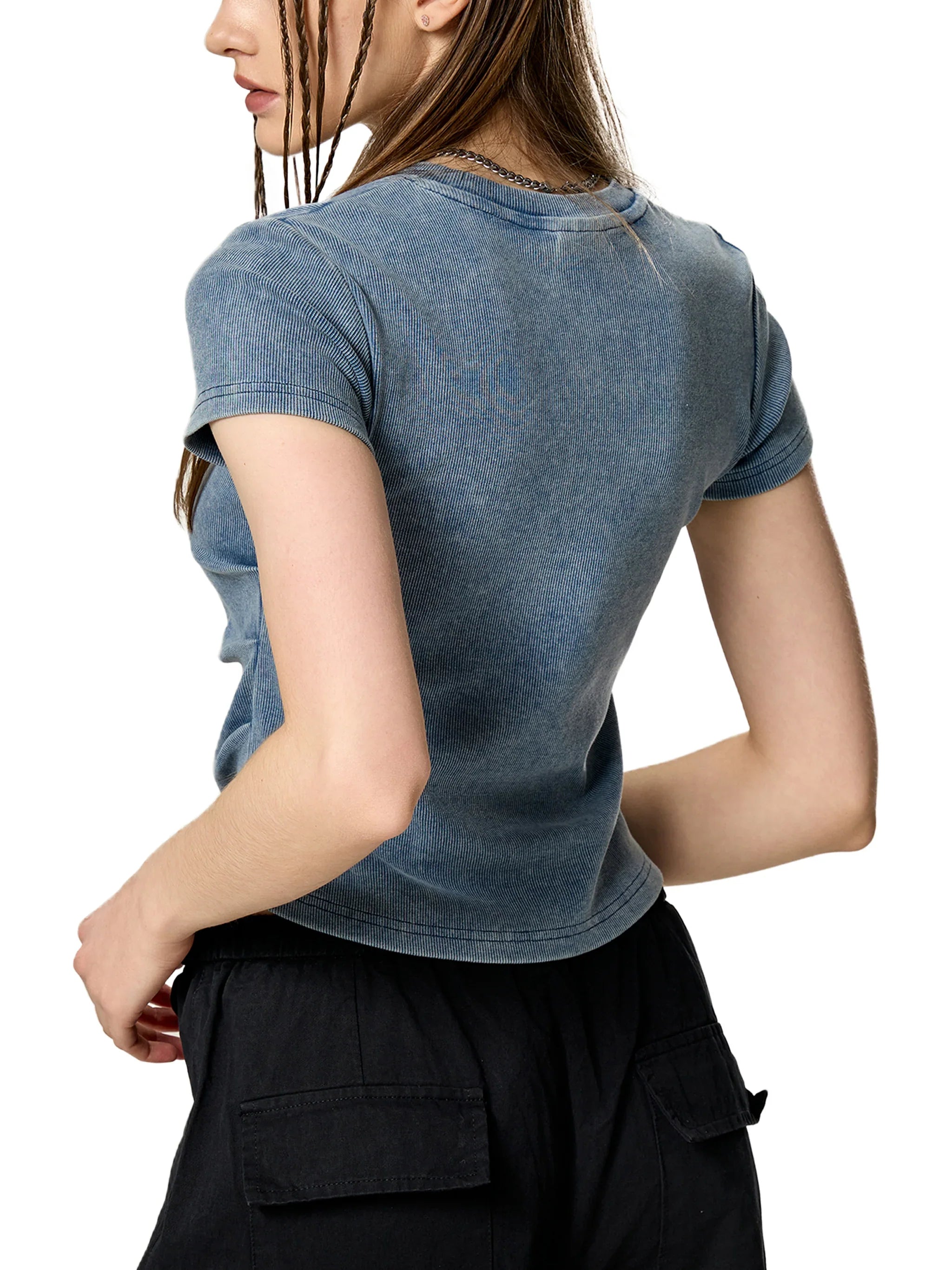 Woman wearing a fitted, washed blue short sleeve t-shirt and black cargo pants