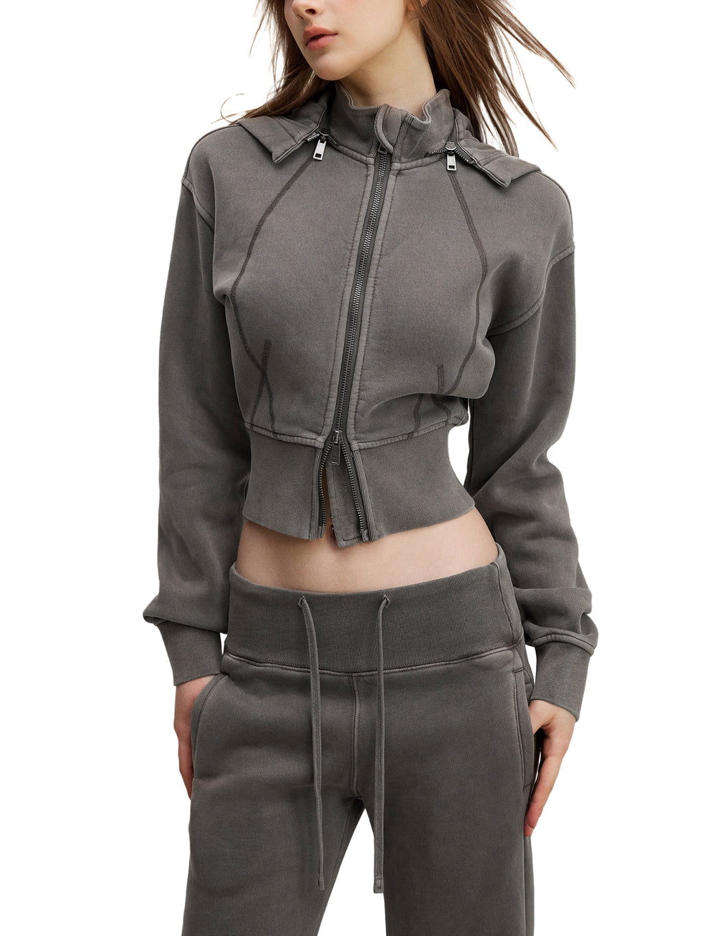 Woman wearing modern cropped zip hoodie and drawstring jogger pants in dark grey