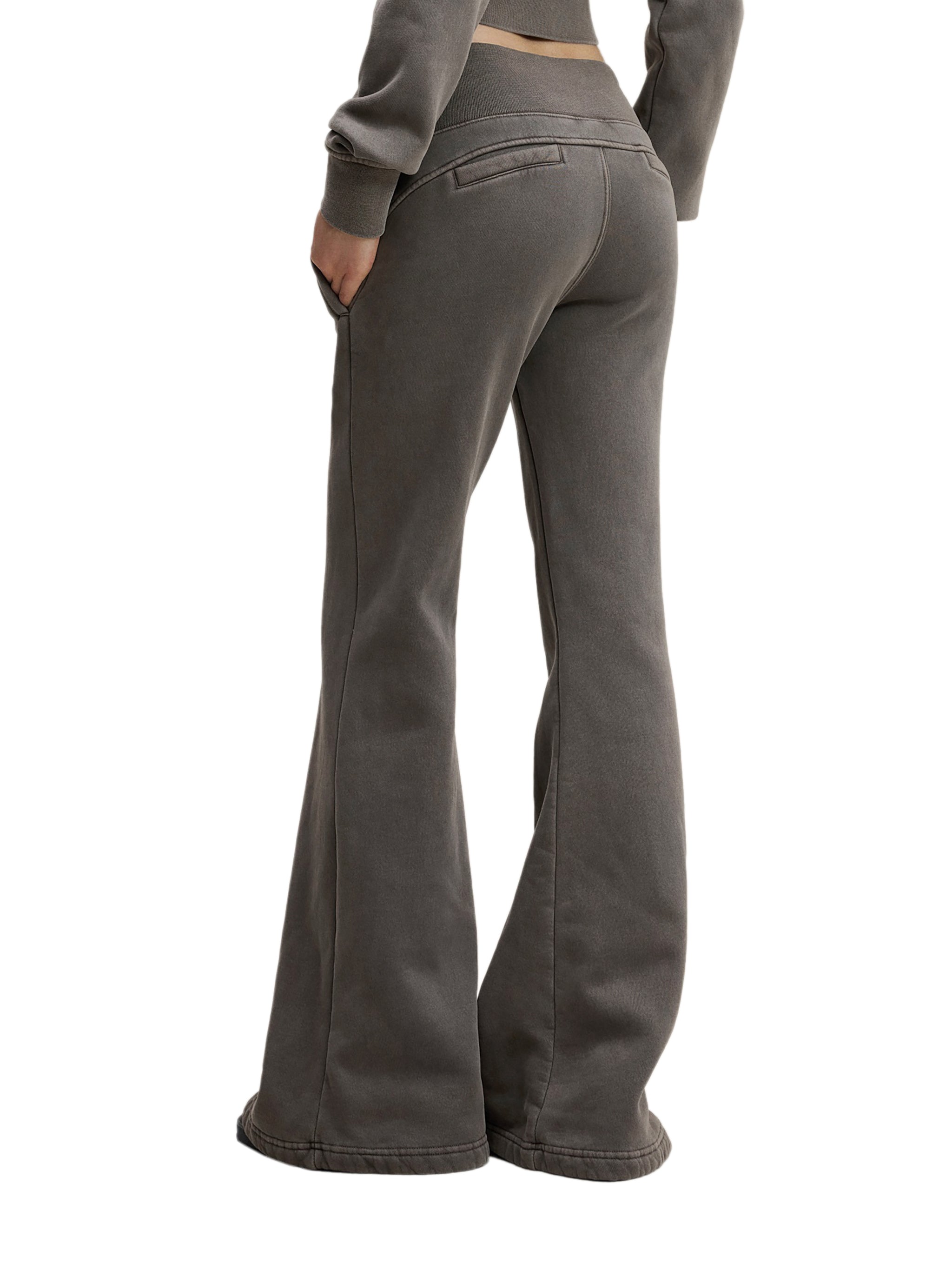 Back view of woman wearing high-waisted, flared grey streetwear pants
