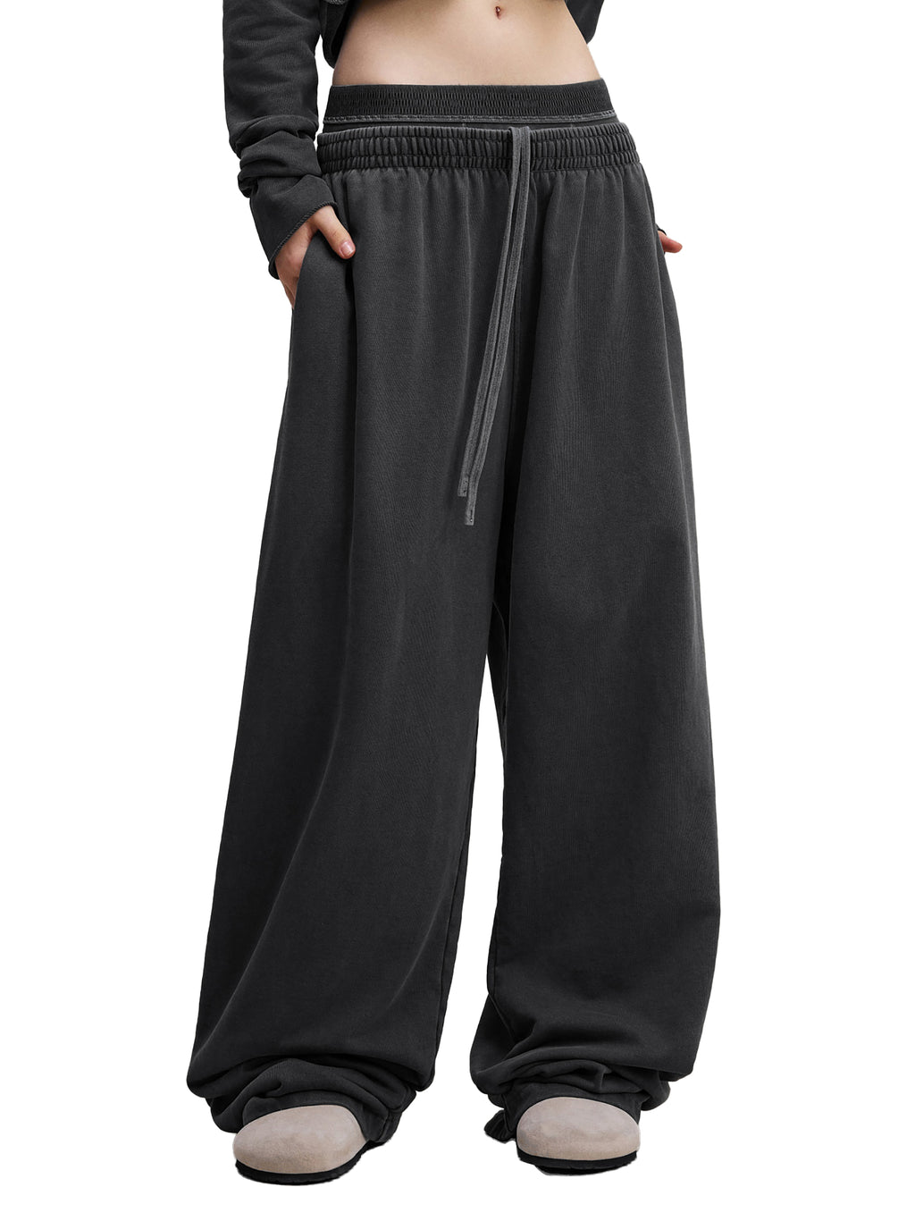 Oversized black wide-leg sweatpants with drawstring waist and relaxed streetwear style