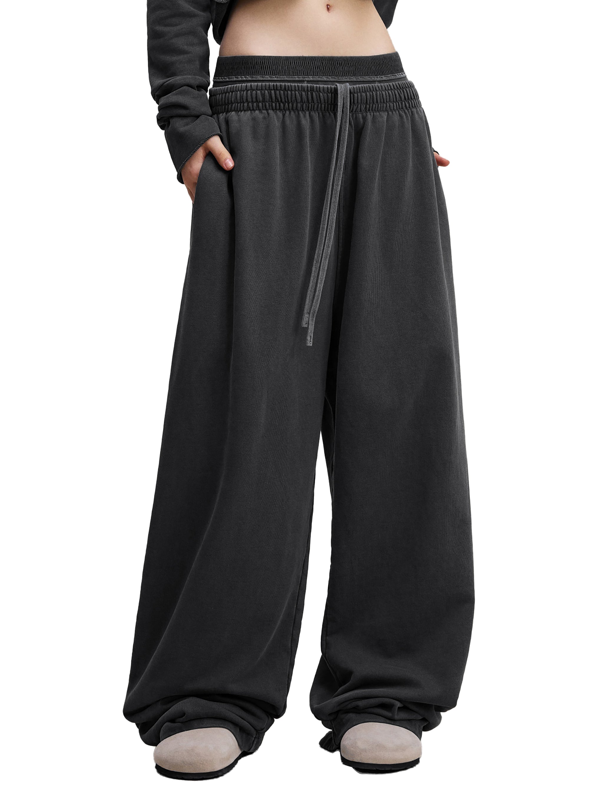 Oversized black wide-leg sweatpants with drawstring waist and relaxed streetwear style