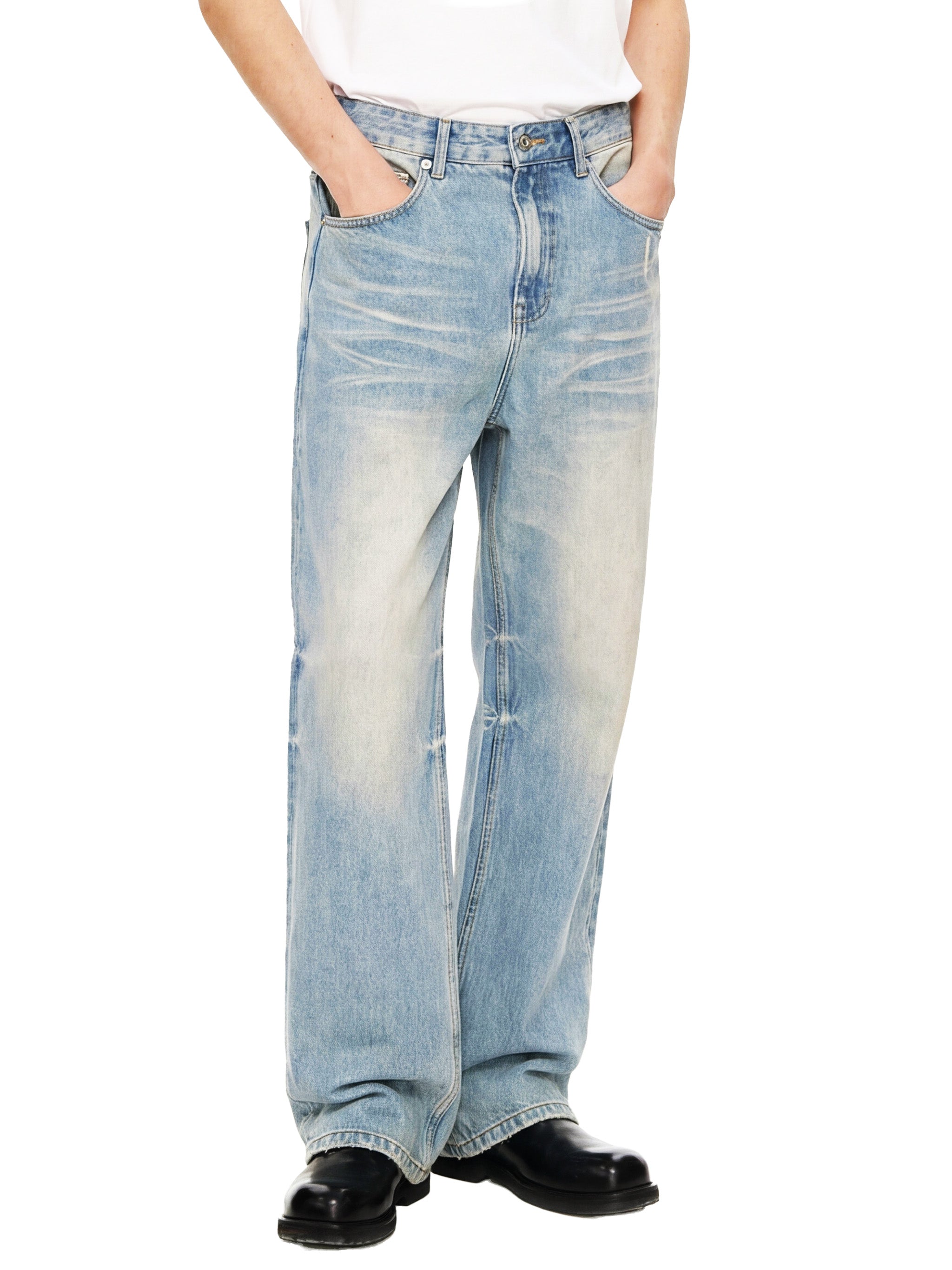 Light wash wide leg jeans styled with a white shirt and black boots, urban streetwear look